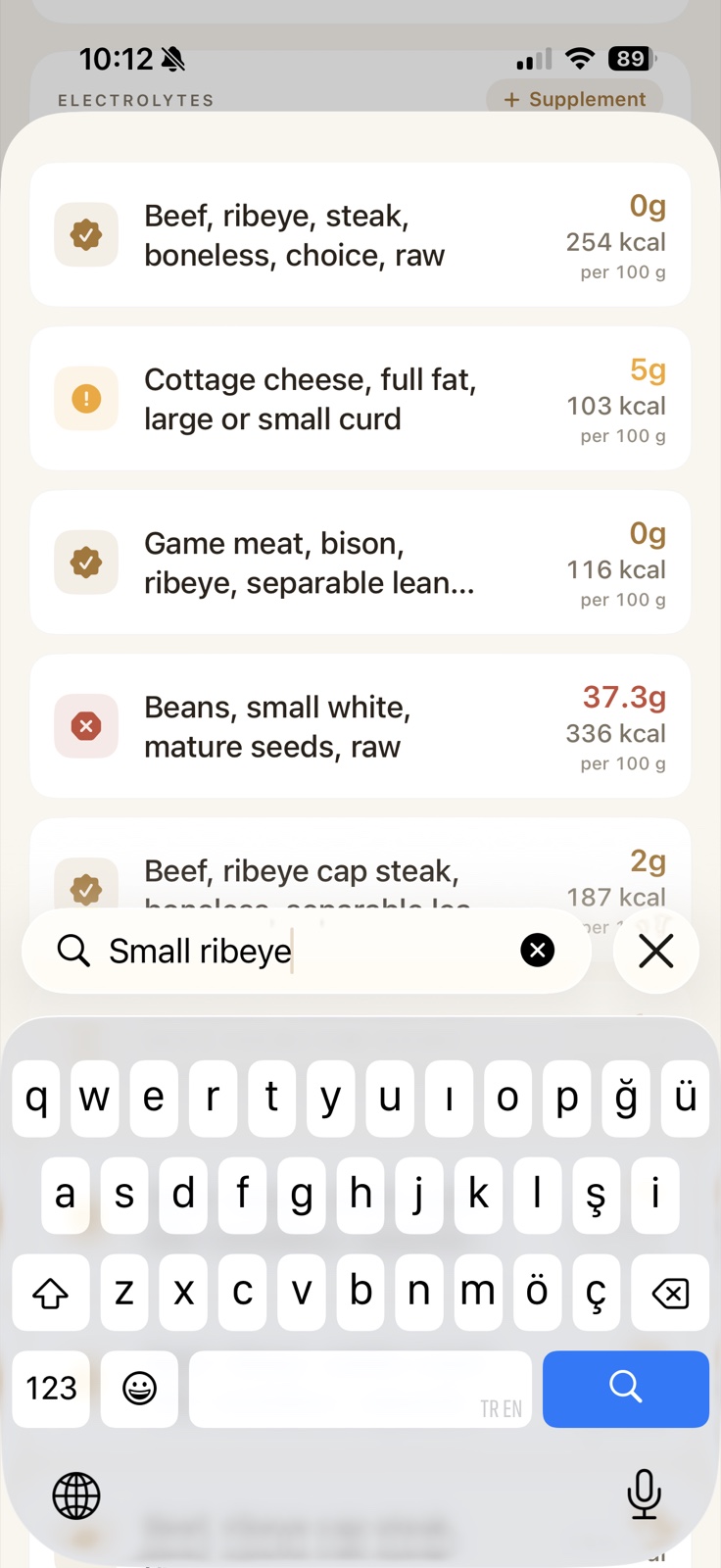 Ketoly smart search results for a ribeye query, with keto-friendly badges and warning chips